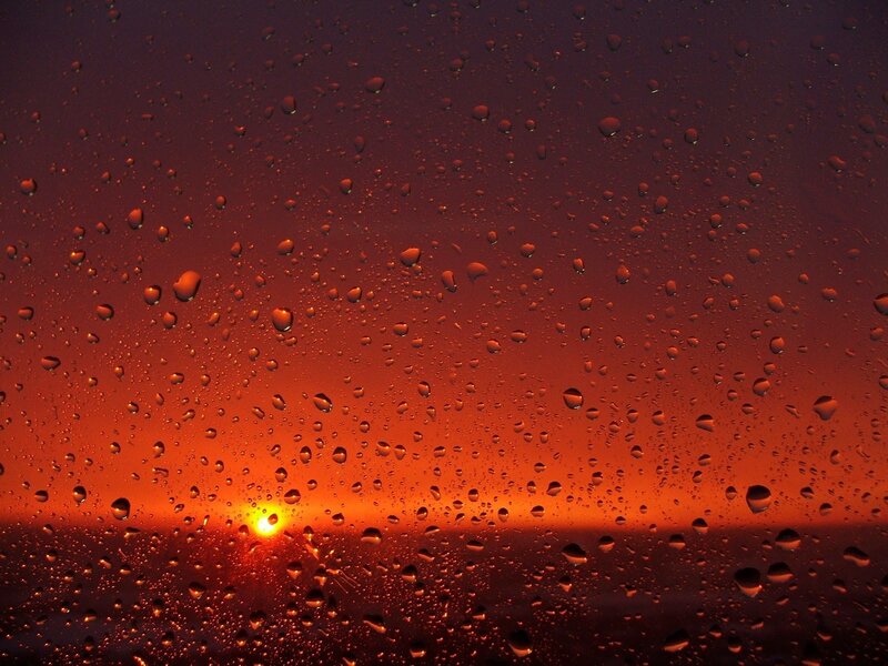 raindrops on window at sunset