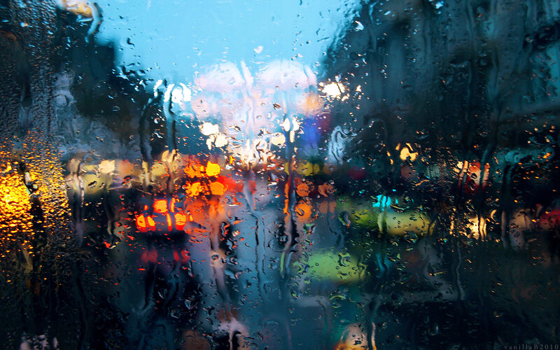 Rainy city lights through a window