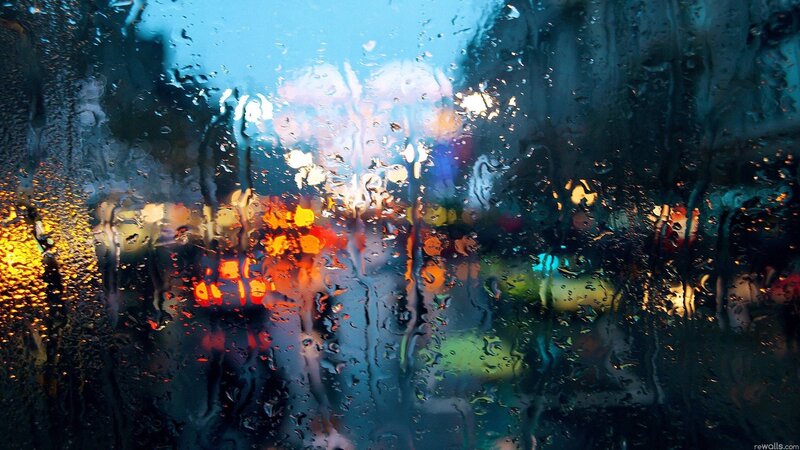 rainy city lights through glass