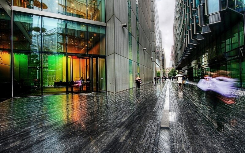 Rainy city street with colorful reflections