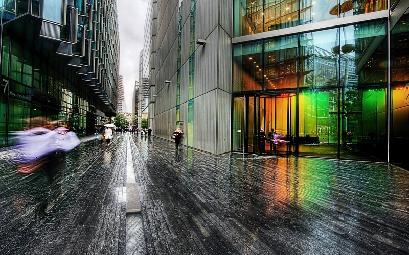Rainy city street with modern buildings