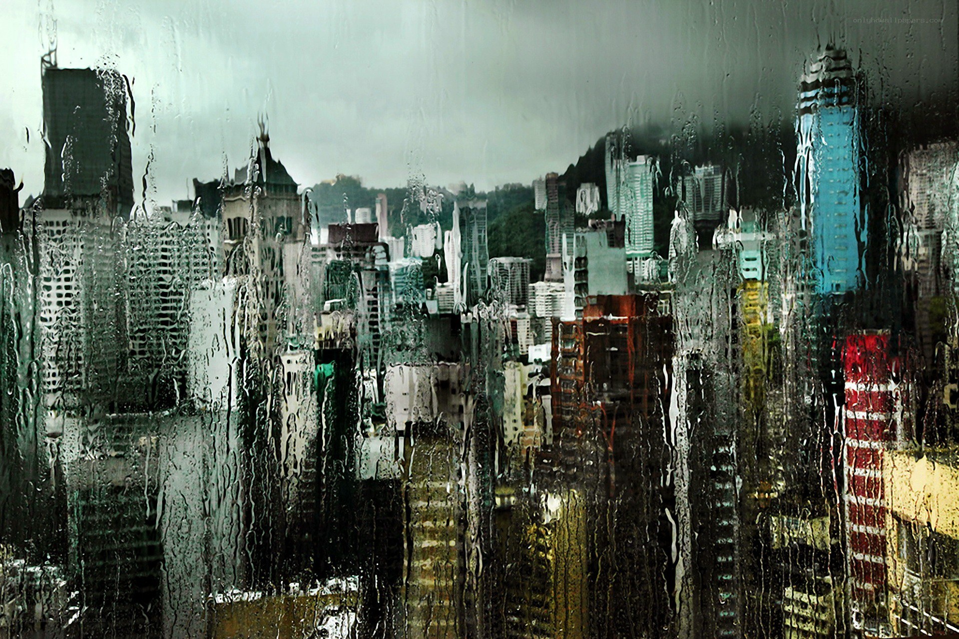 rainy cityscape through wet glass