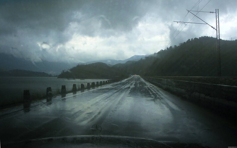 Rainy road by a lake