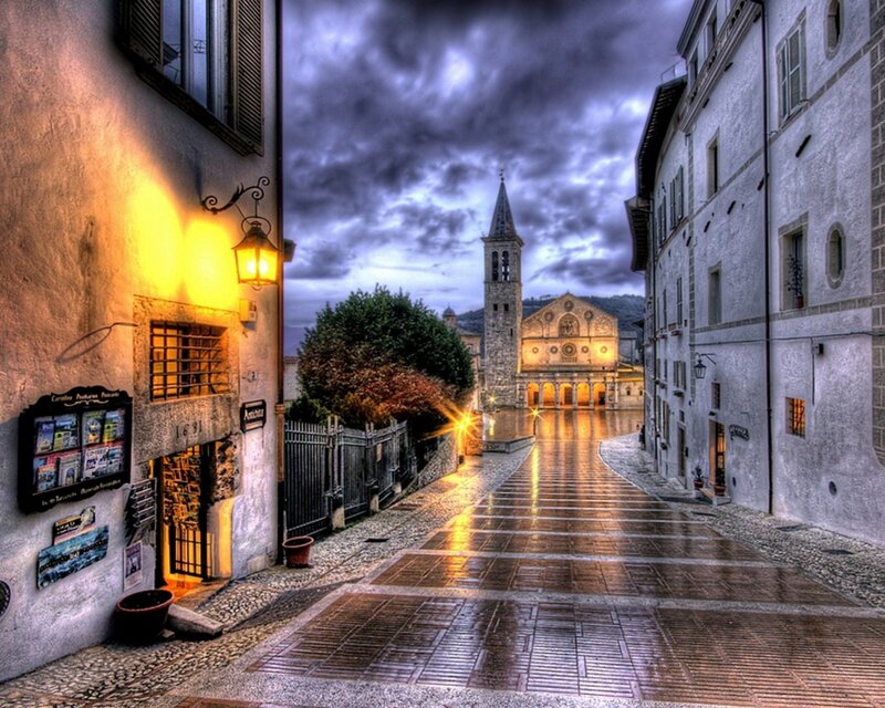 rainy street leading to a church