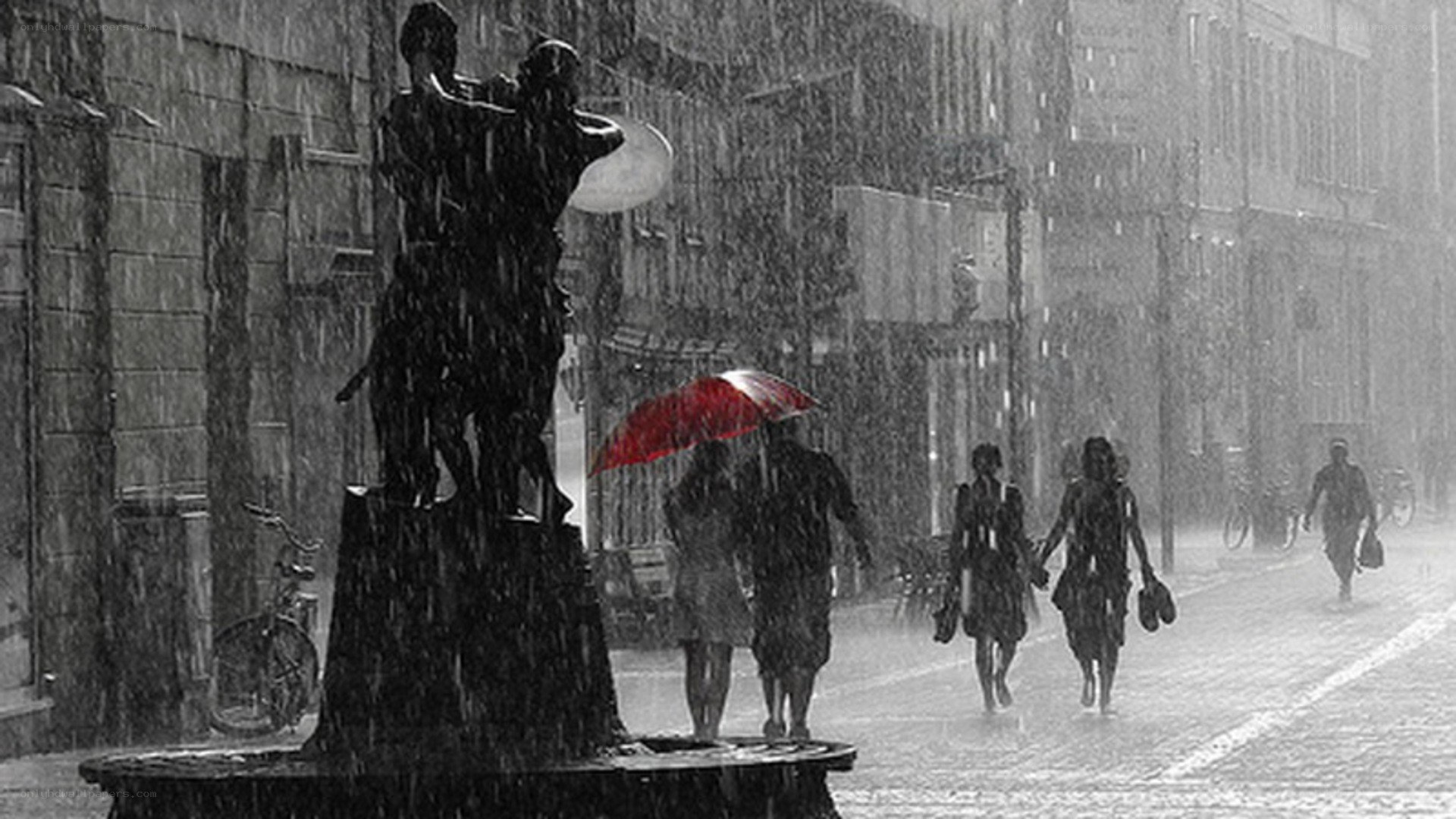 Rainy street with red umbrella