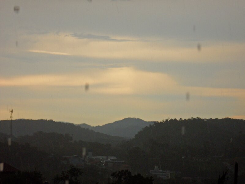 Rainy view of hills at dusk
