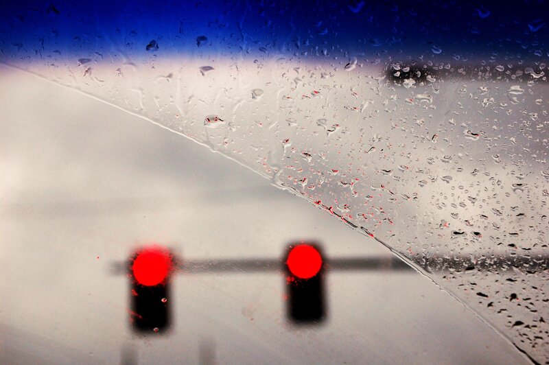 Rainy window with red lights