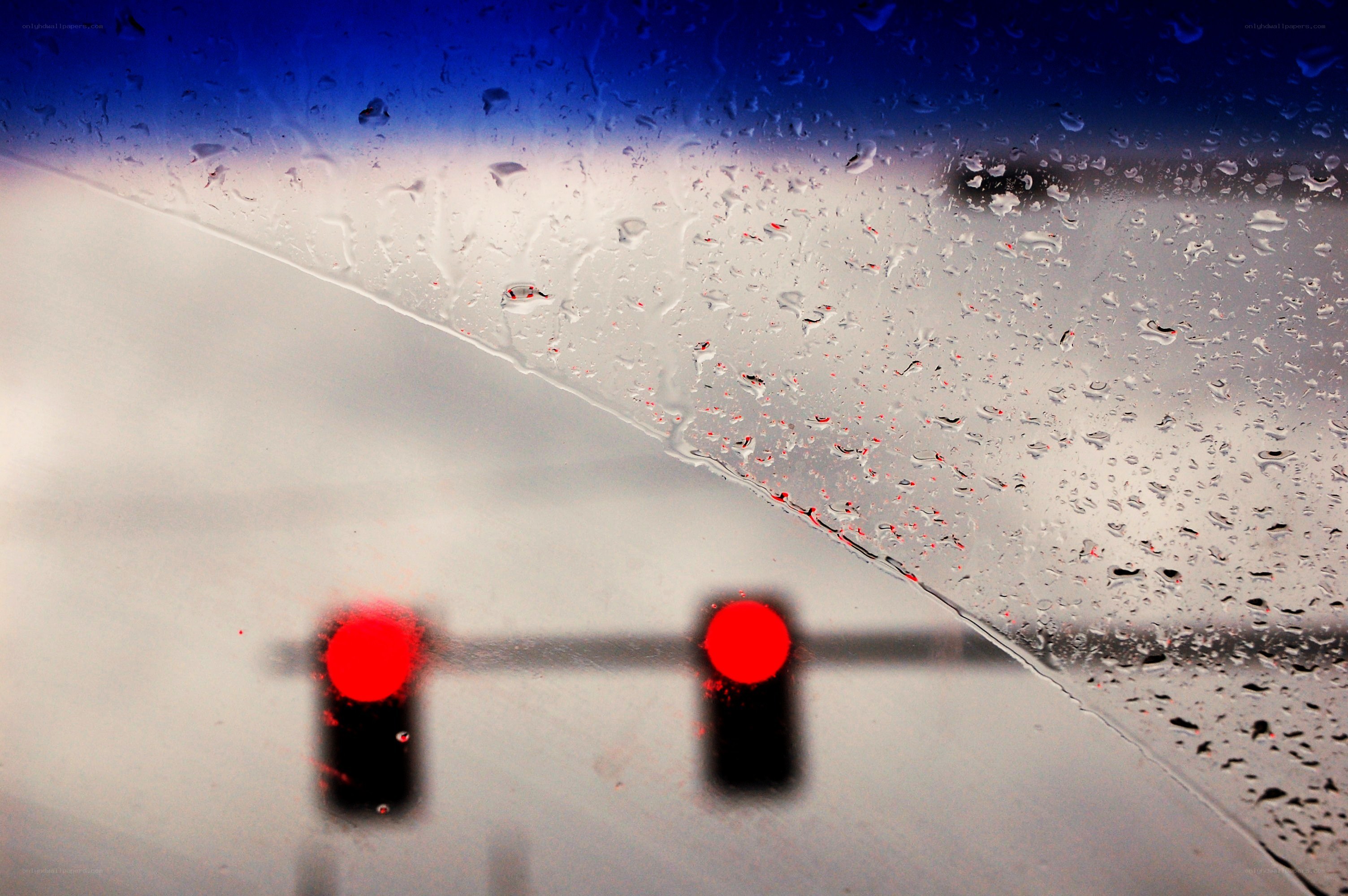 Rainy window with red lights