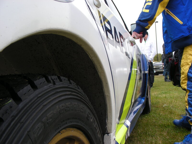 rally car and crew on grass