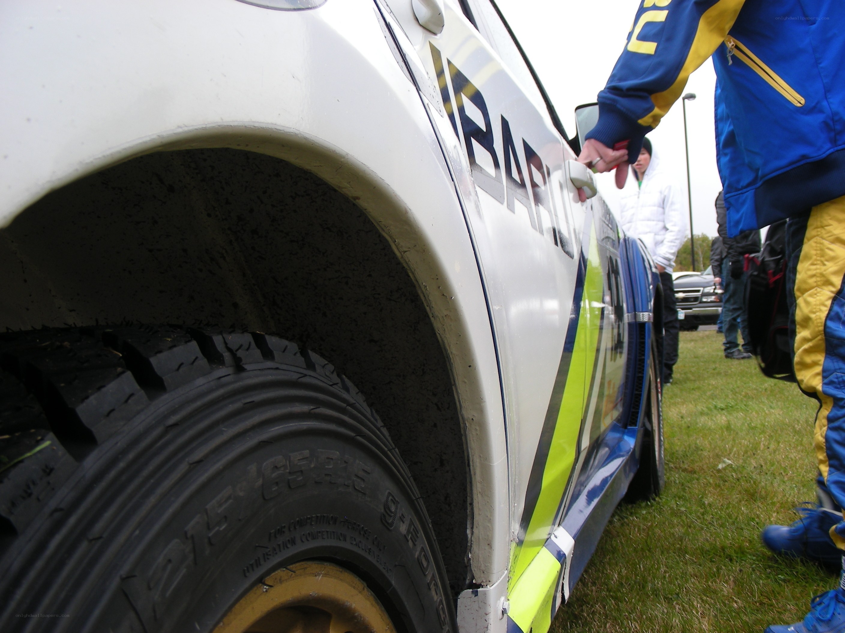 rally car and crew on grass