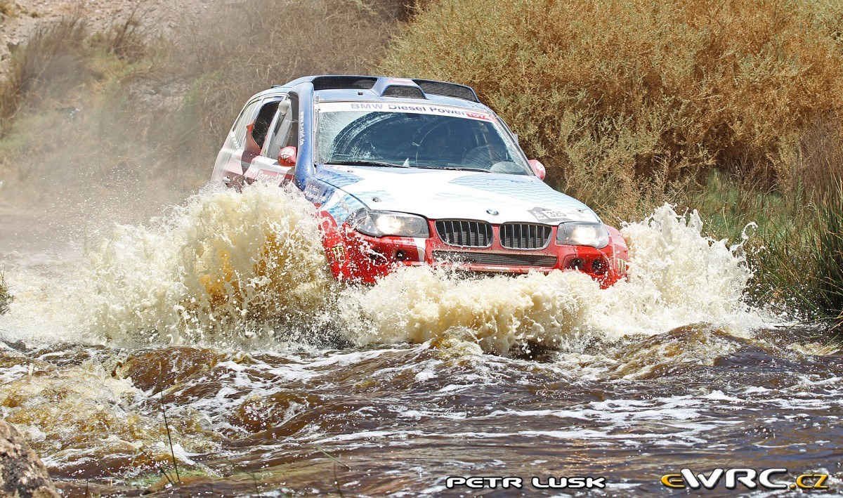 Rally car crossing a river