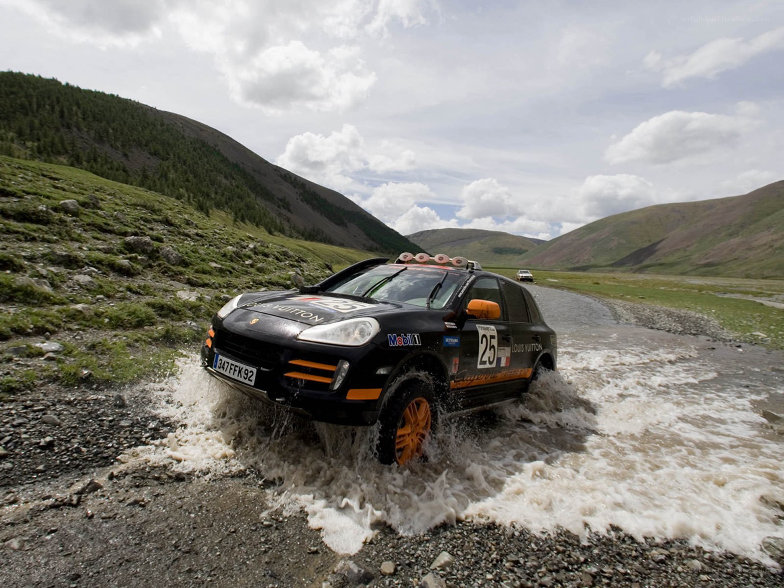 Rally car crossing river