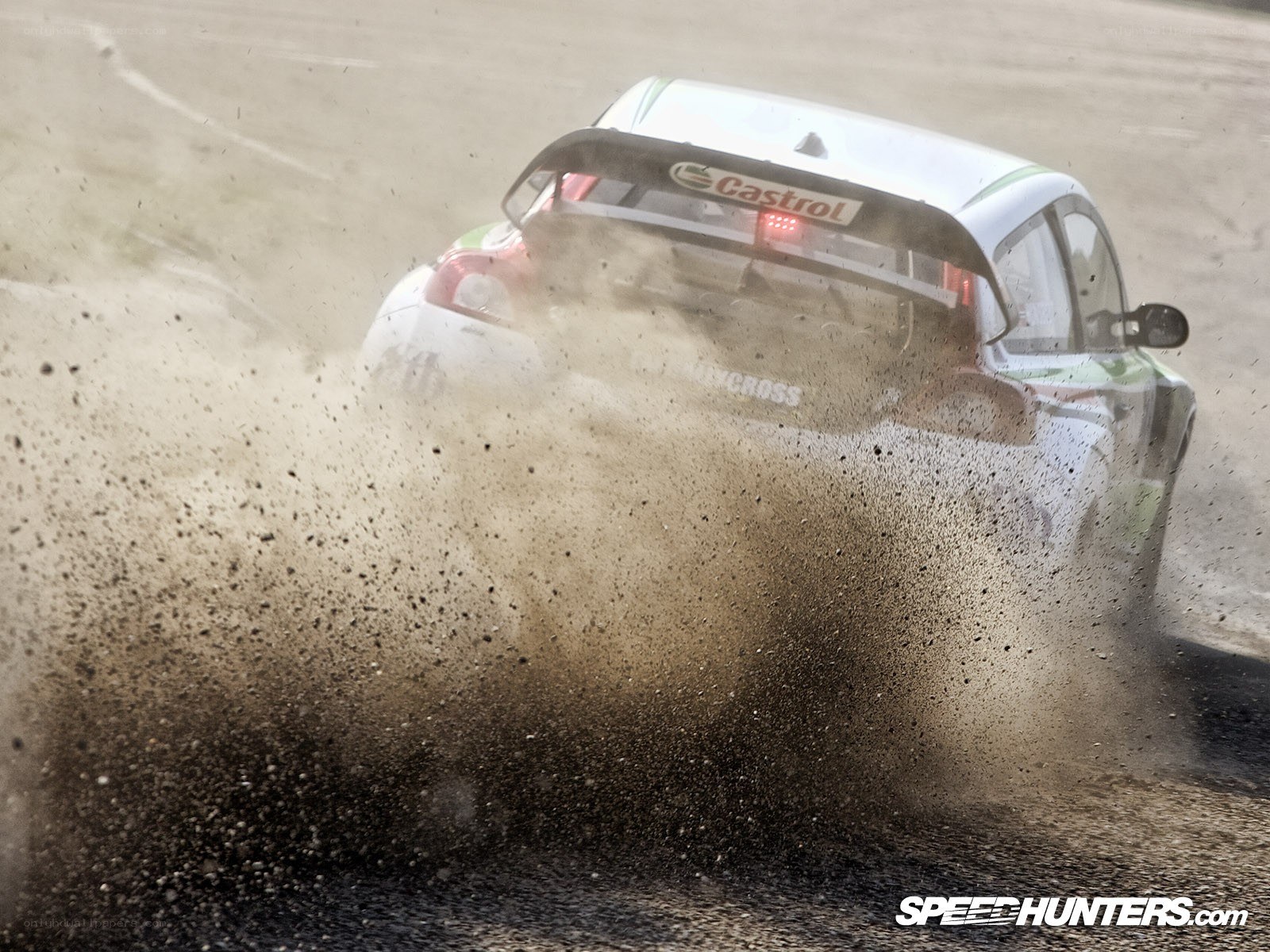 rally car drifting on dirt