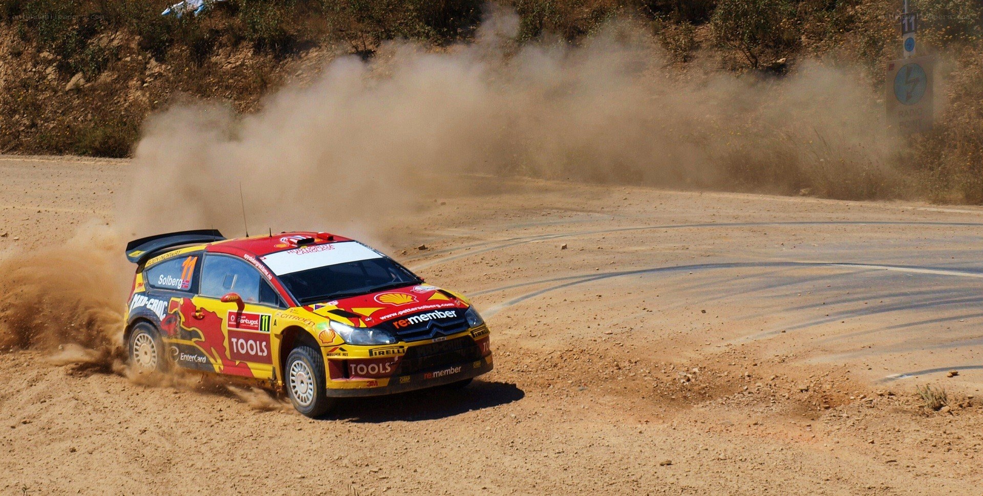 rally car drifting on dirt