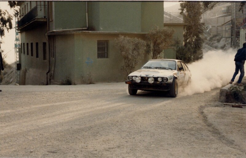 rally car drifting on dirt road