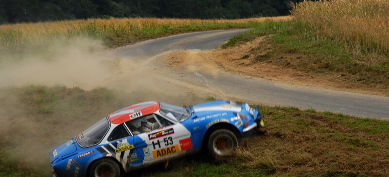 Rally car drifting on dirt road