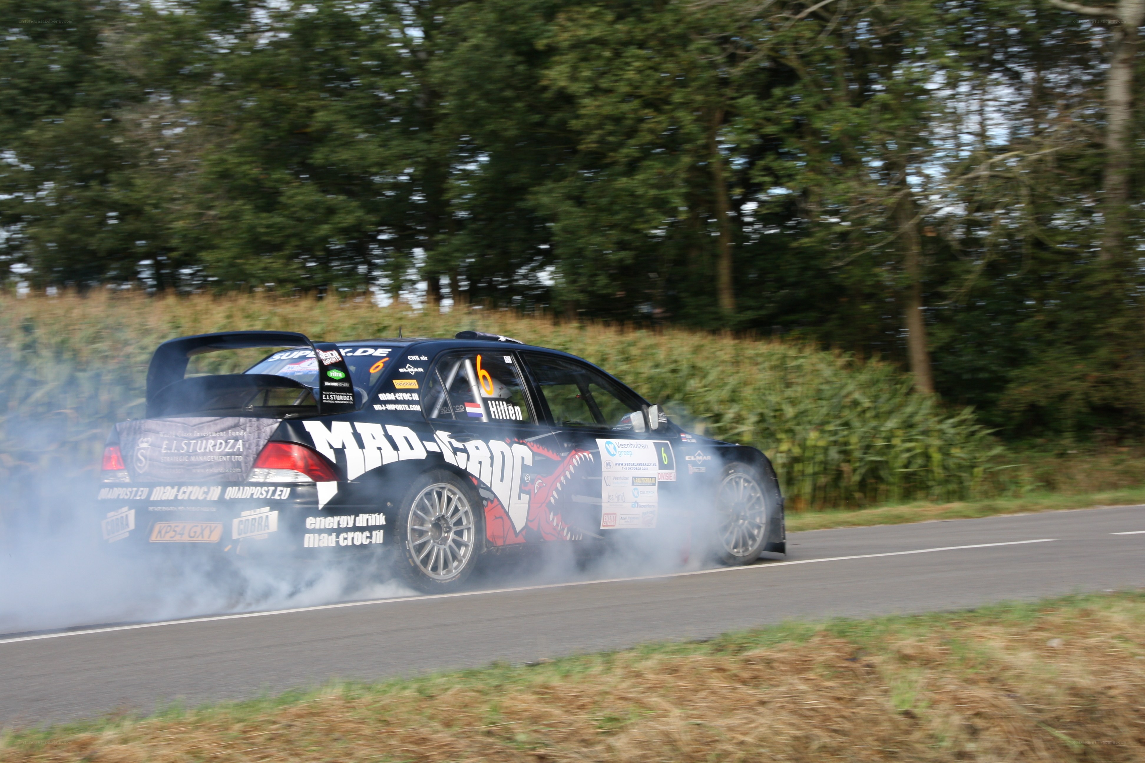 rally car drifting on road