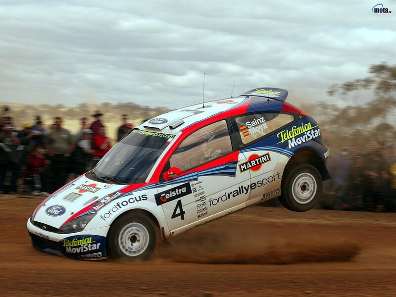 Rally car in action on dirt track