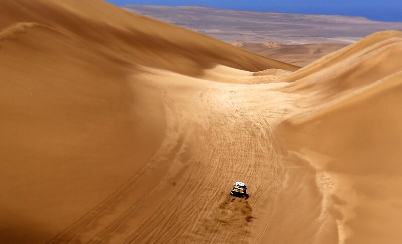 Rally car in desert dunes