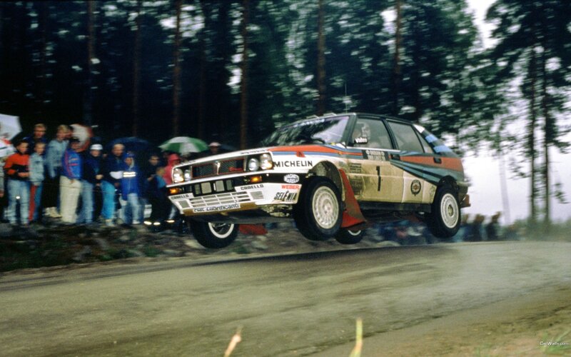 Rally Car in Mid-air — Green, Dynamic, Photograph, Crowd
