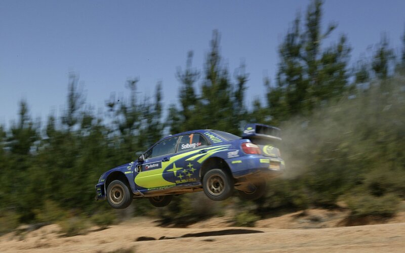 rally car in mid-air jump