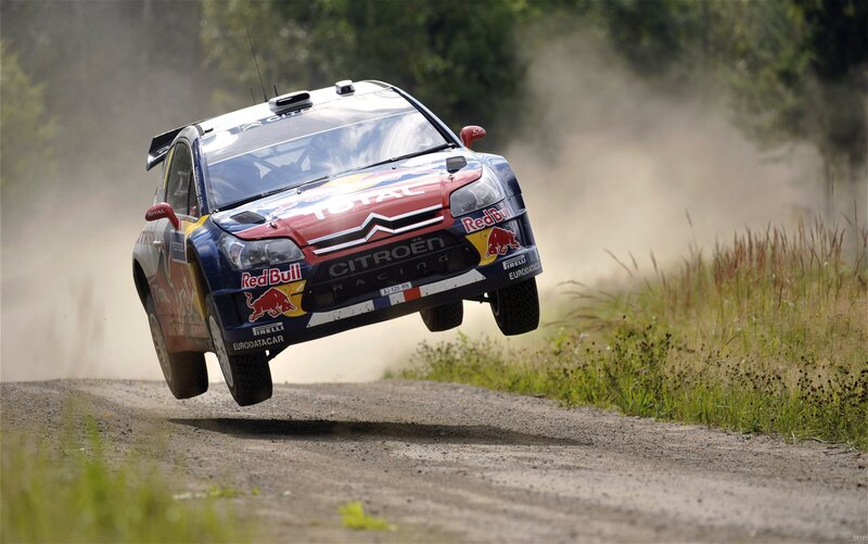 rally car in mid-air jump