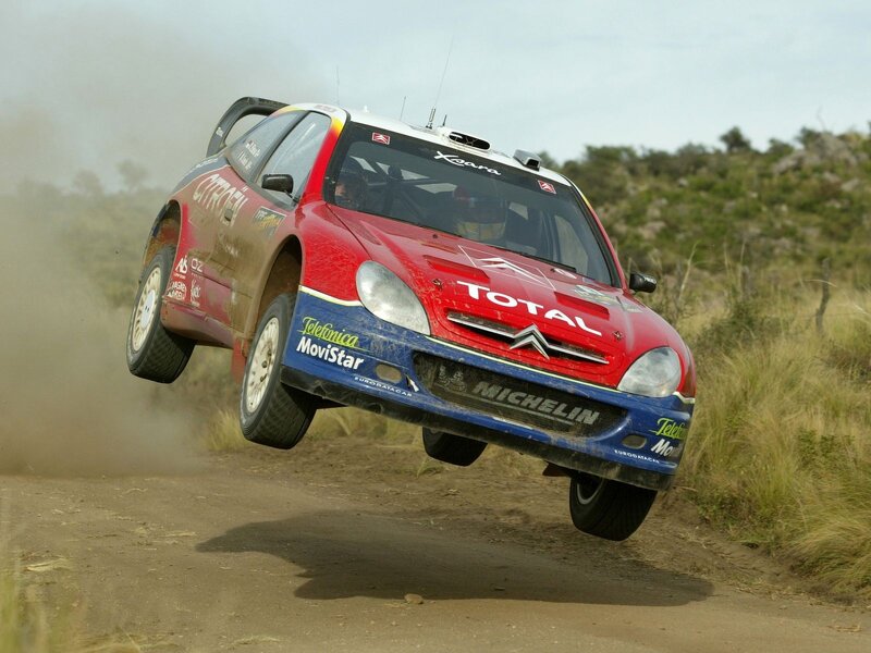 rally car in mid-air jump
