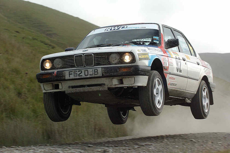 rally car in mid-air jump