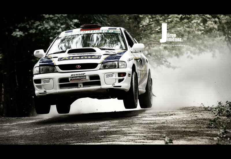 rally car in mid-air jump