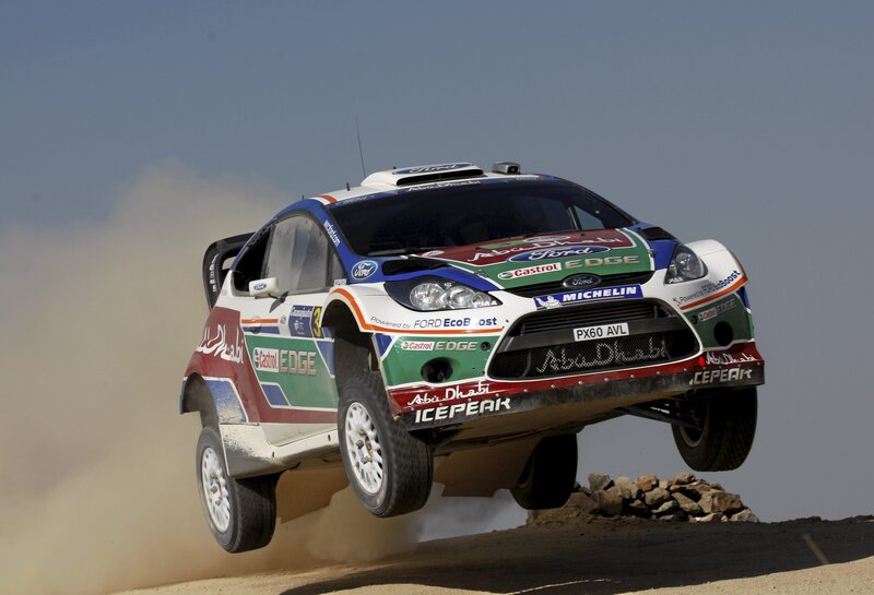 rally car in mid-air jump