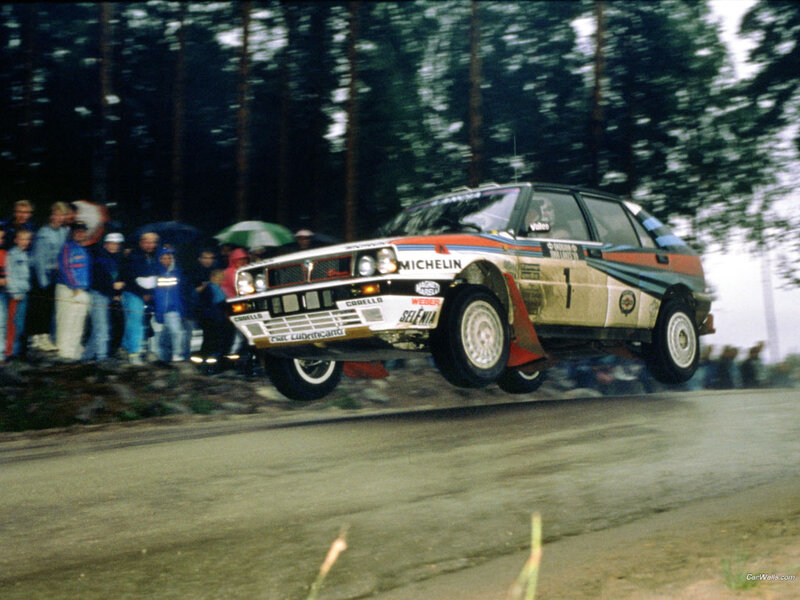 Rally Car in Mid-air — White, Dynamic, Photograph, Crowd