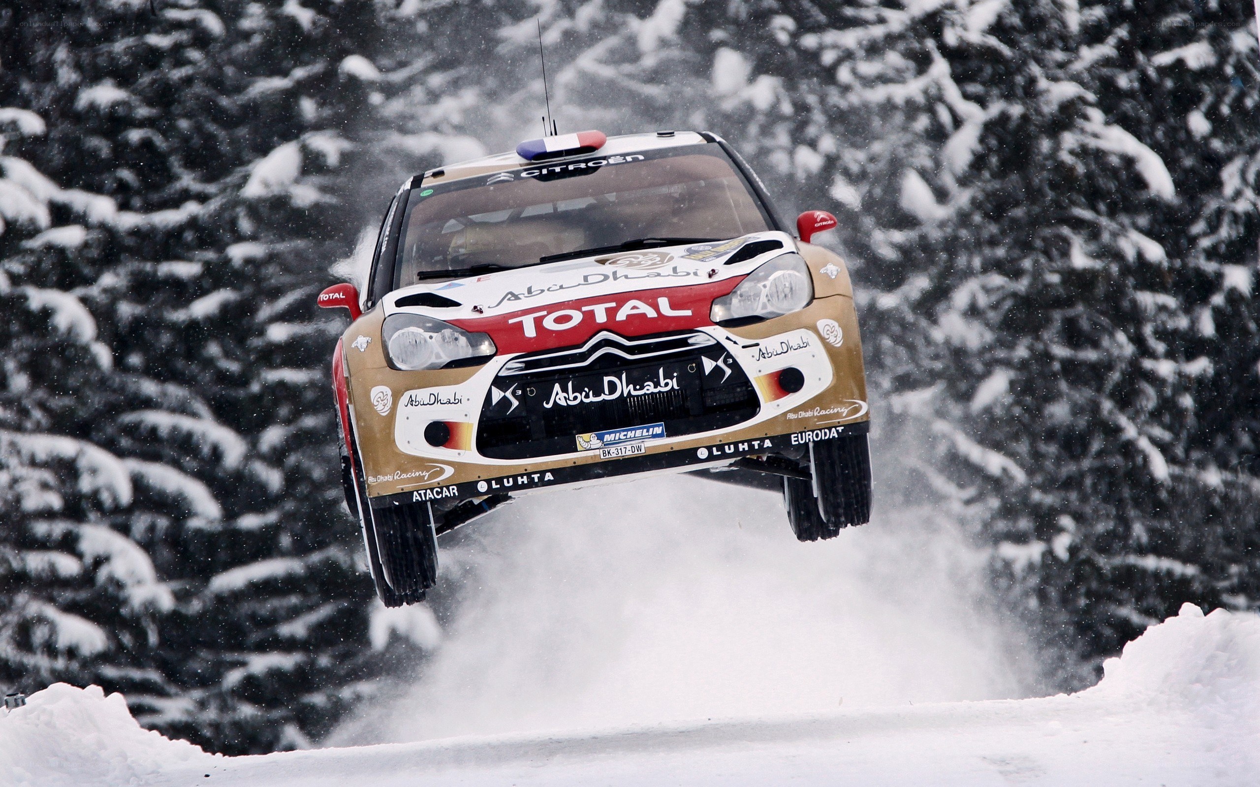 Rally car jumping in snow
