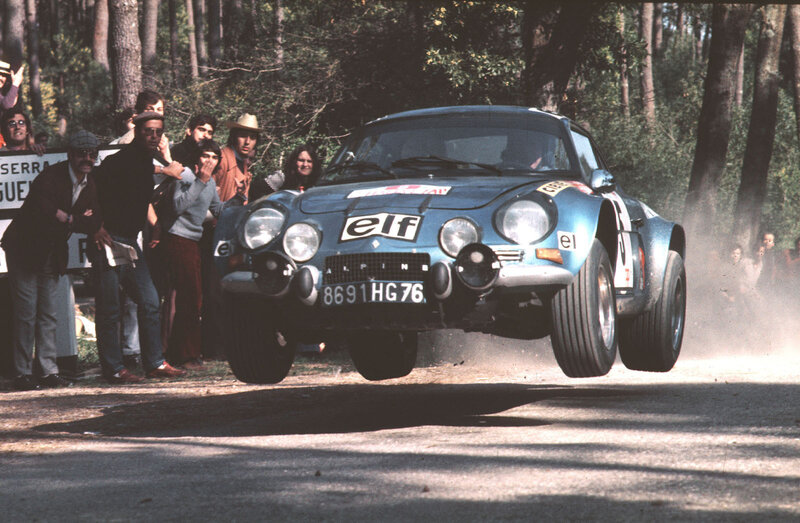 rally car jumping on dirt road