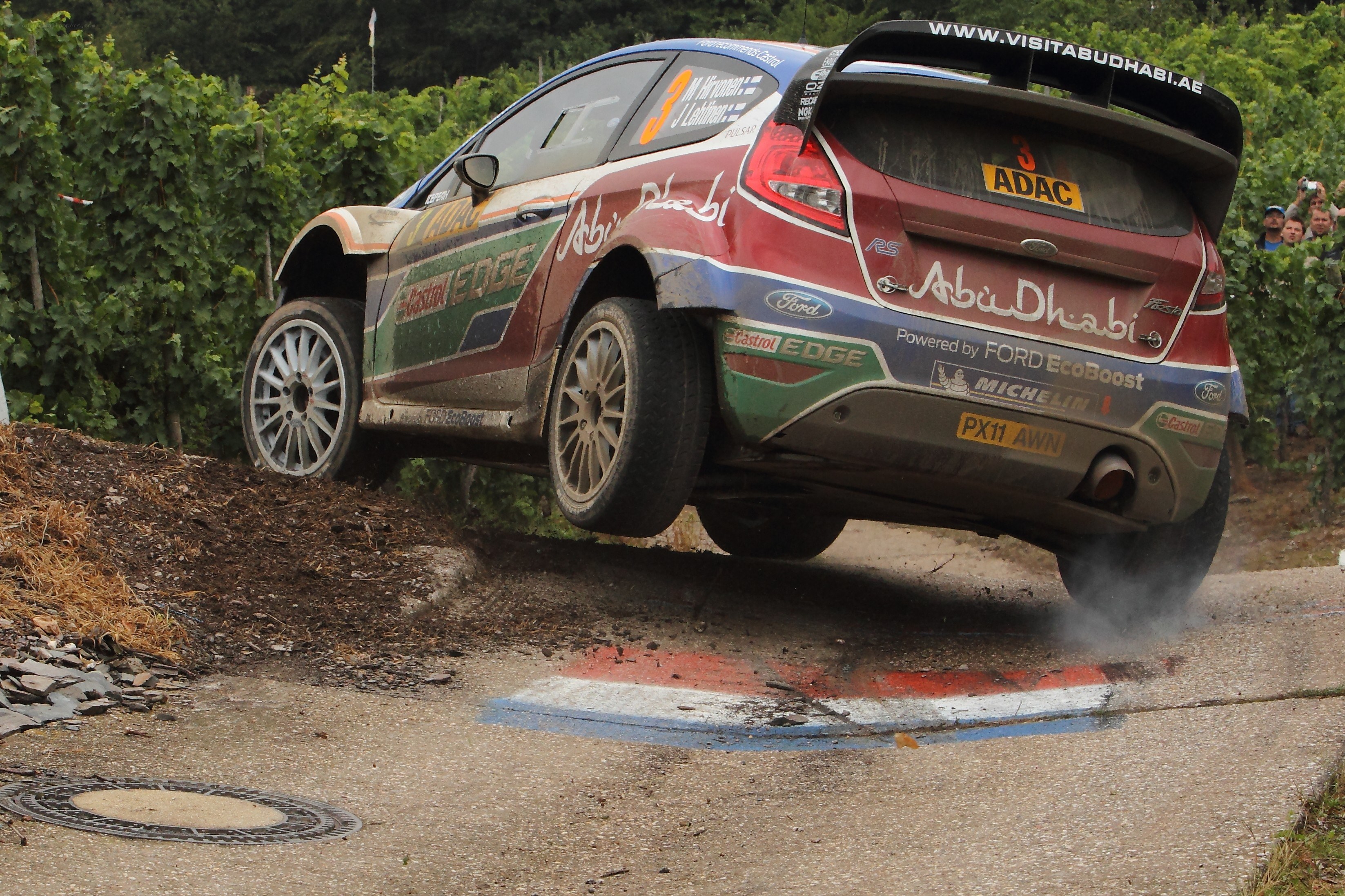 Rally car jumping over a bump