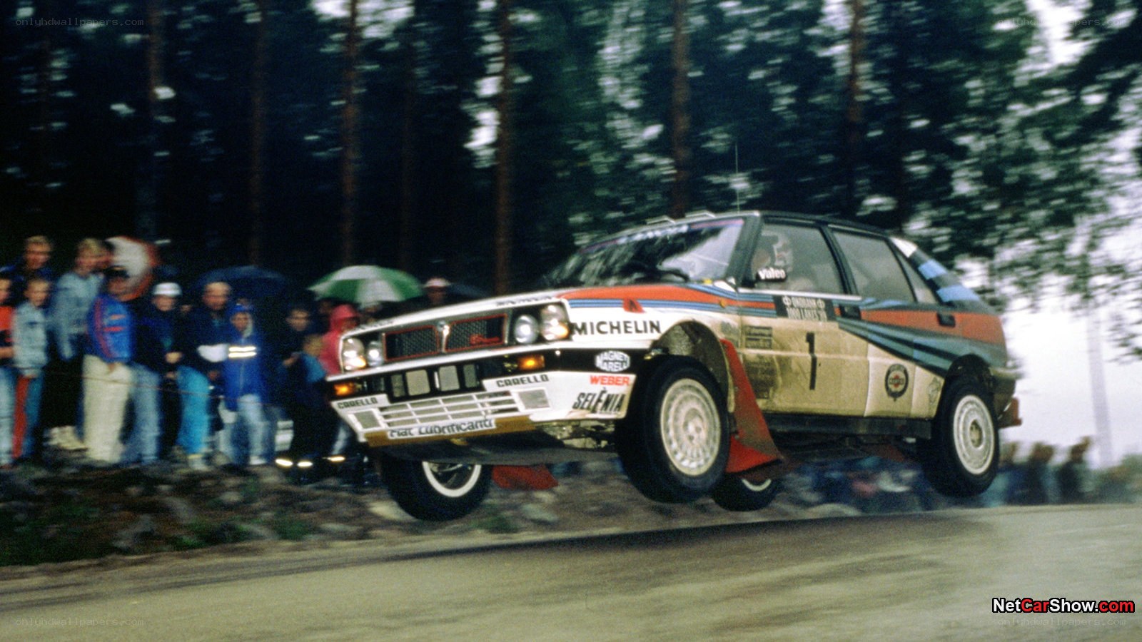 rally car jumping over obstacle