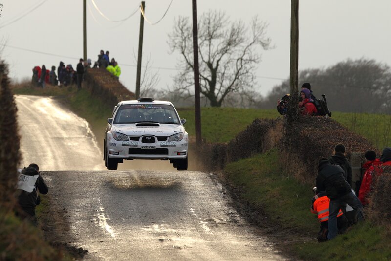 Rally car jumps on wet road