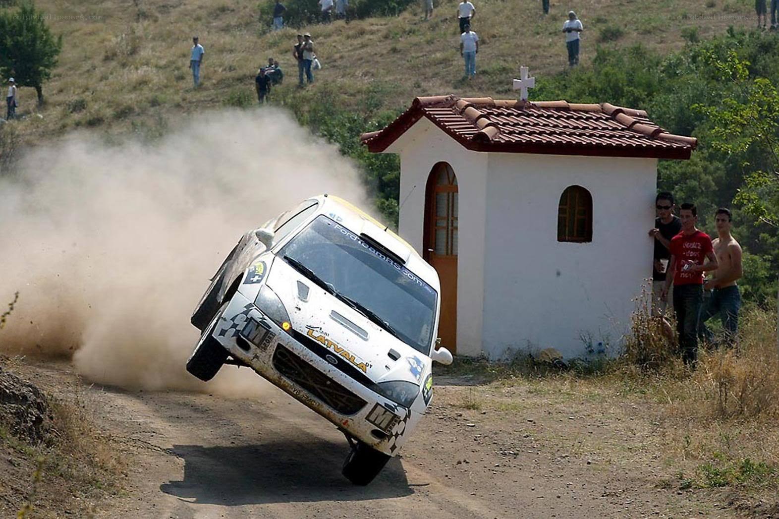 Rally car jumps over dirt road