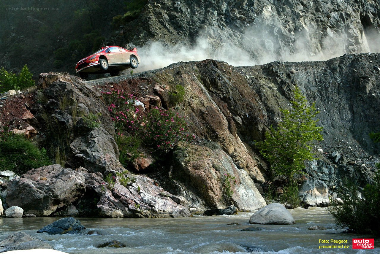 Rally car jumps over river