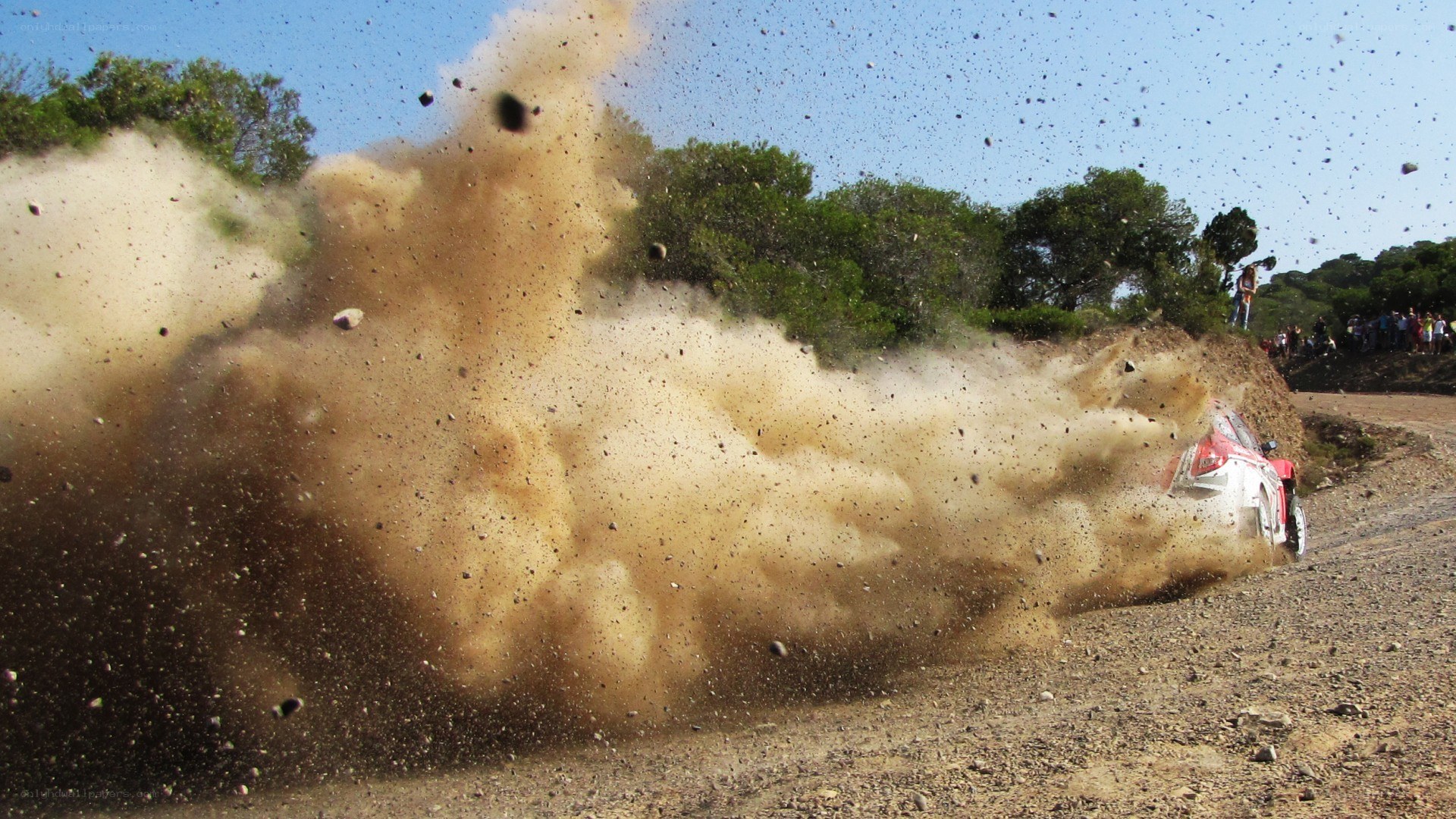 Rally car kicking up dust