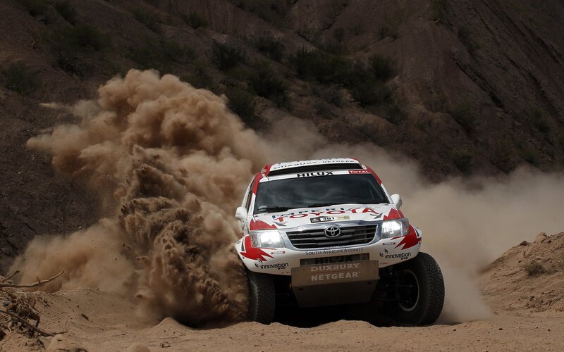 Rally car kicking up dust