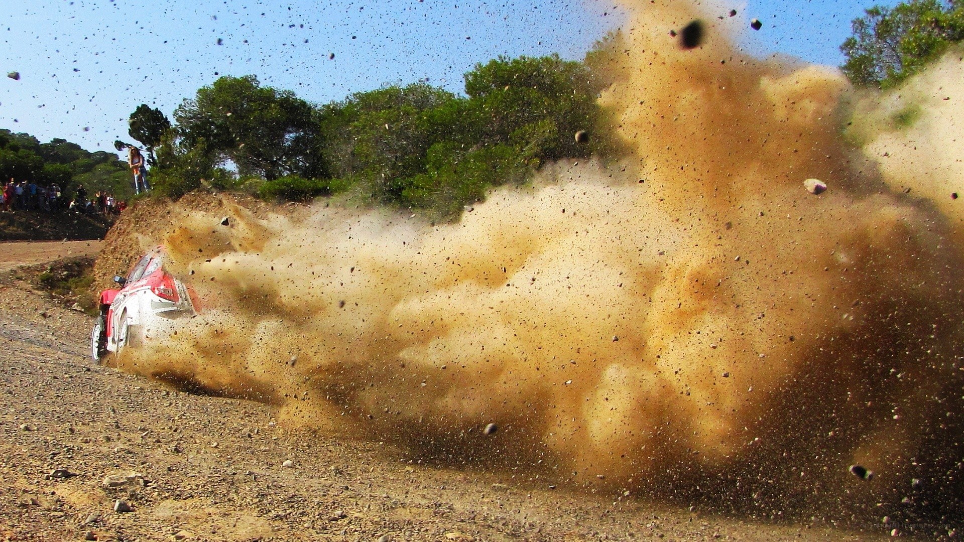 Rally car kicking up dust