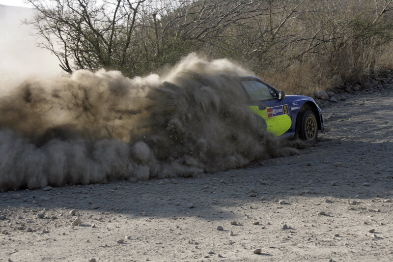 Rally car kicking up dust