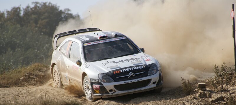 Rally car kicking up dust