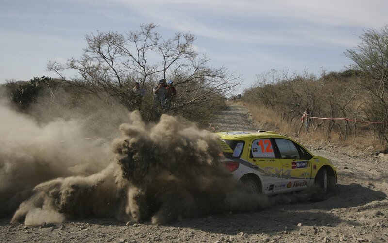 Rally Car Kicking Up Dust — Yellow