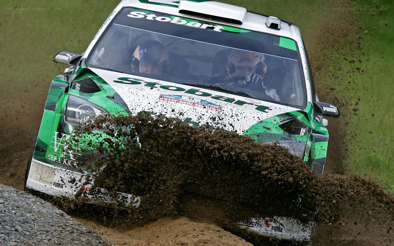 Rally car kicking up mud
