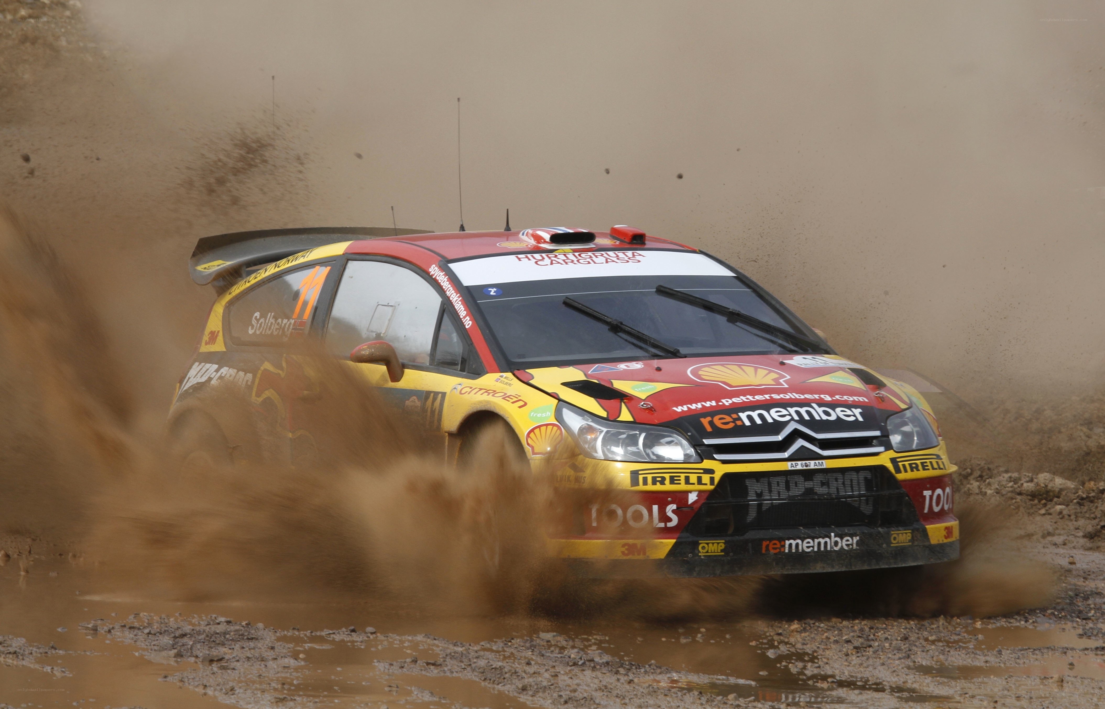 Rally car kicking up mud