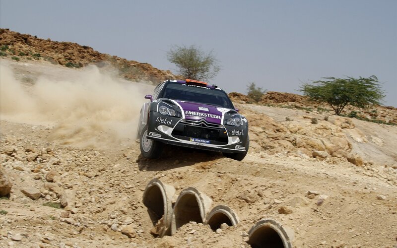 Rally Car on Dirt — Brown, Dynamic, Afternoon, Photograph, Dust, Rocks, Trees