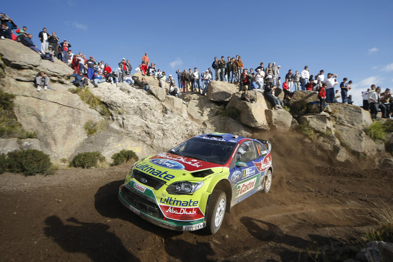 Rally Car on Dirt — Green, Dynamic, Afternoon, Photograph, Crowd, Rocks