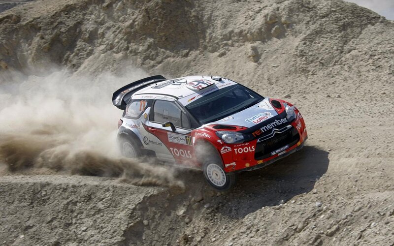 Rally Car on Dirt — Red, Dynamic, Afternoon, Photograph, Dirt Track, Dust Cloud, Hill