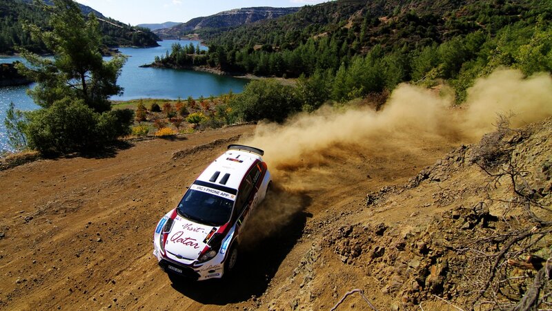 Rally Car on Dirt Road — Brown, Dynamic, Afternoon, Photograph, Dirt Road, Lake, Trees, Green